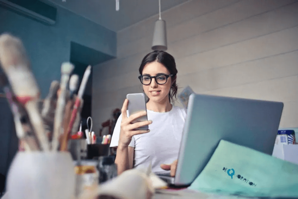 Woman making payment using mobile phone
